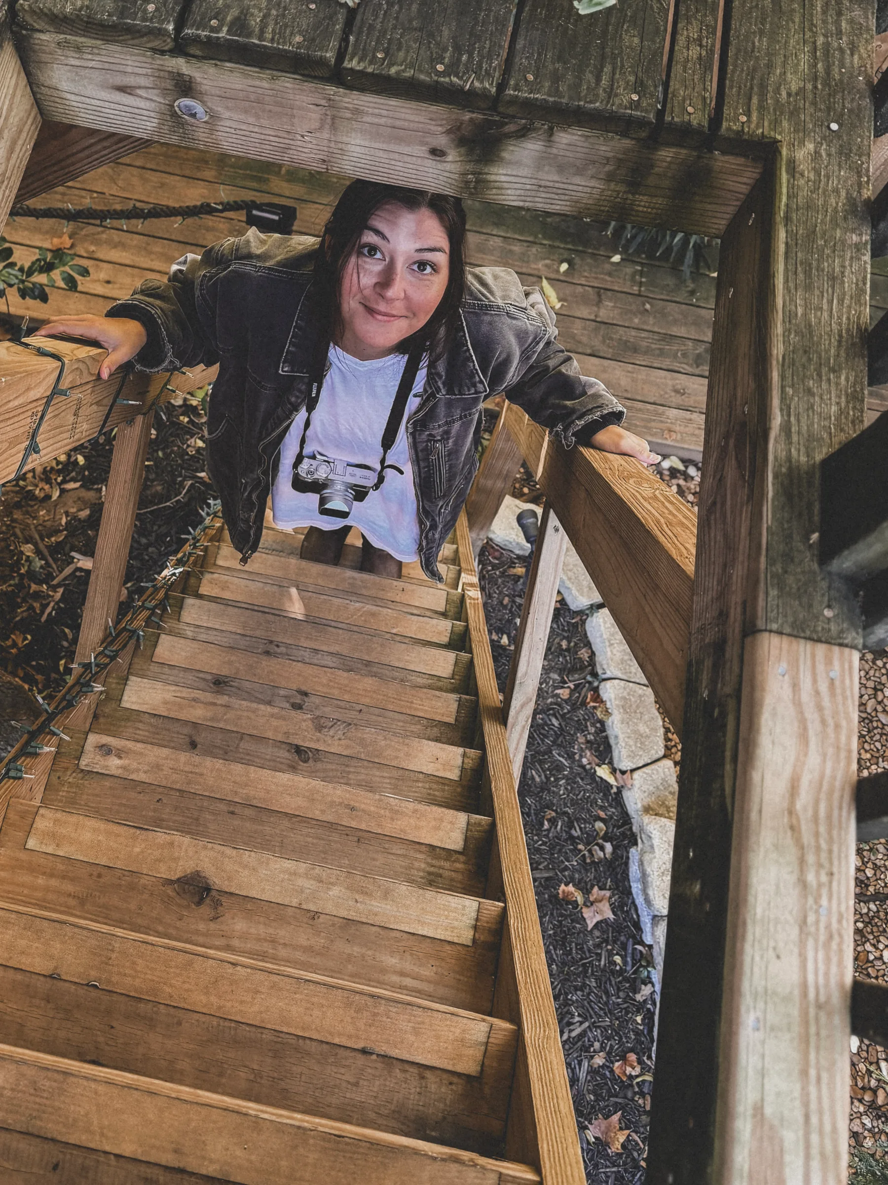 dana looking up from a treehouse in atlanta, georgia